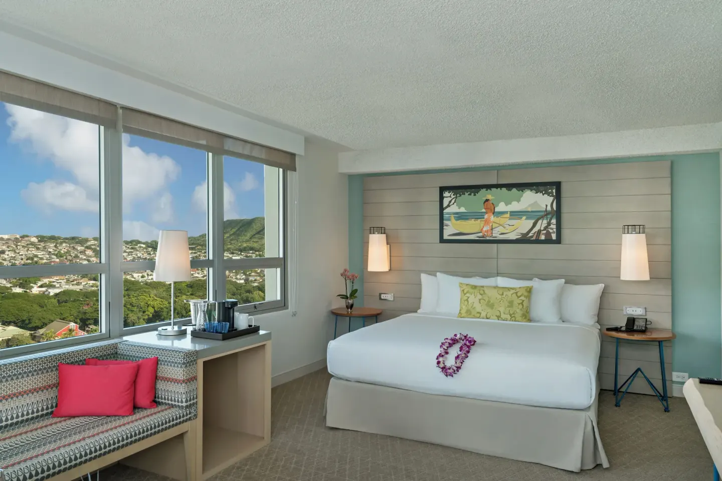 King bed city view room with large windows at Queen Kapiolani Hotel.