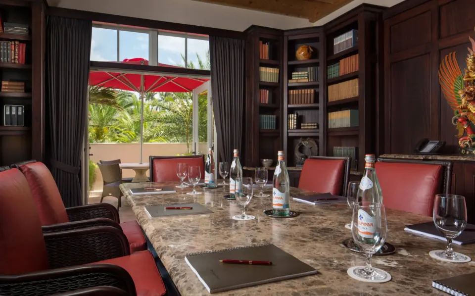 Boardroom table with bottled water and balcony at Quintessence Hotel