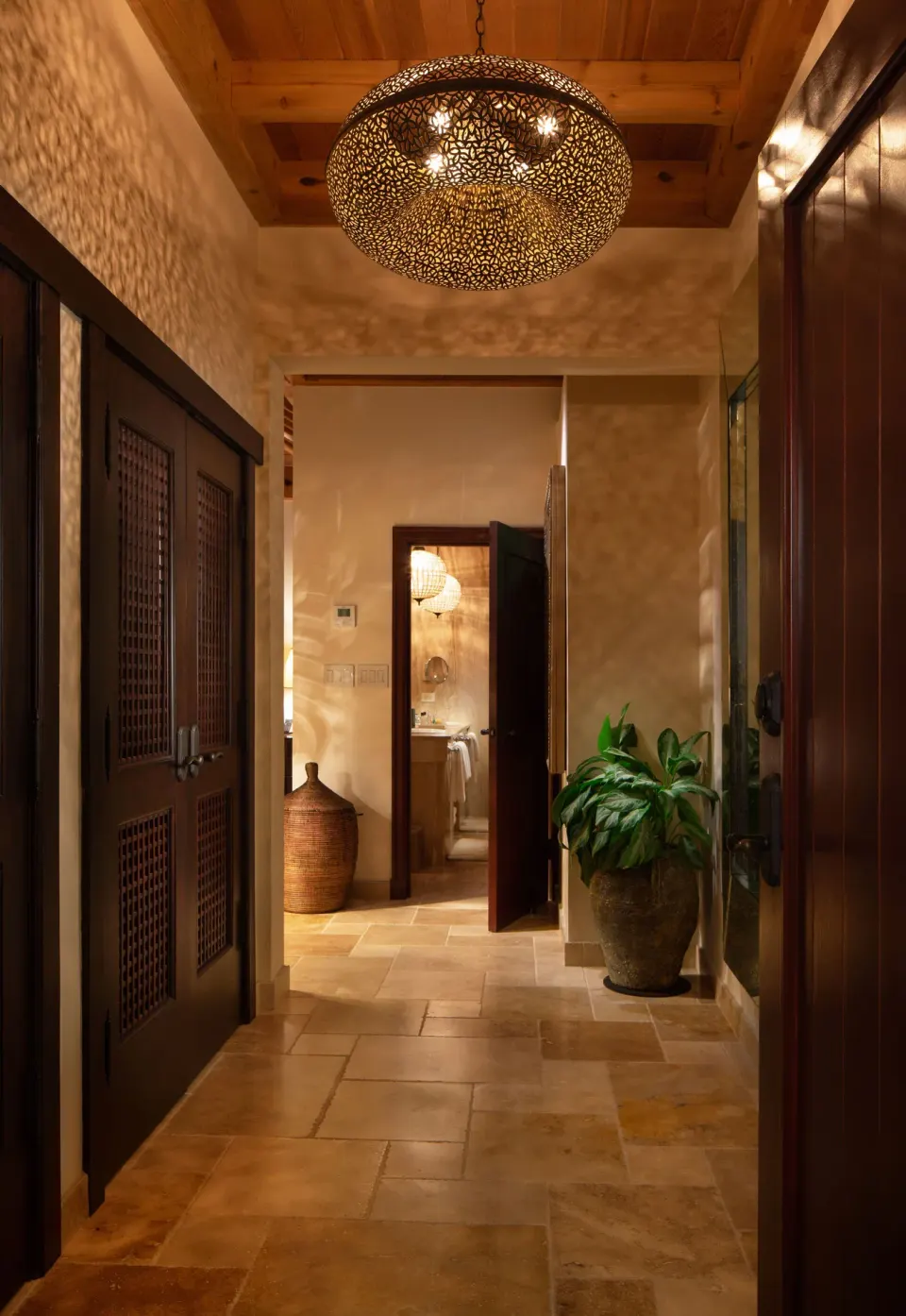 Decorative hotel corridor with tiled floor and pendant light at Quintessence Hotel