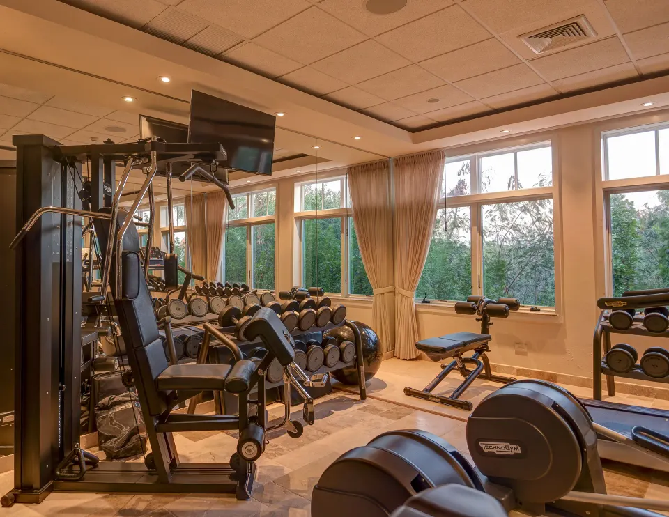 Resort fitness center with weights and machines at Quintessence Hotel.