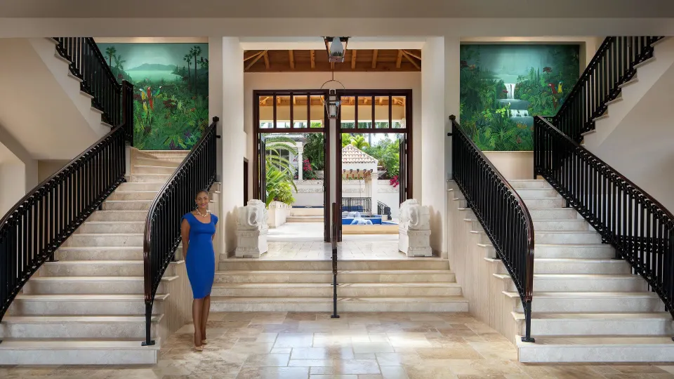 Grand lobby with twin staircases and entrance at Quintessence Hotel
