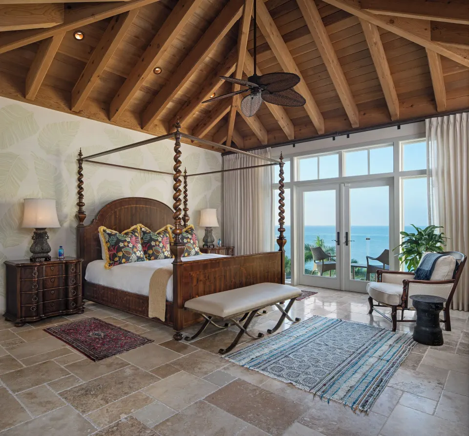 Open suite sitting area with doors to a terrace and an ocean view at Quintessence Hotel