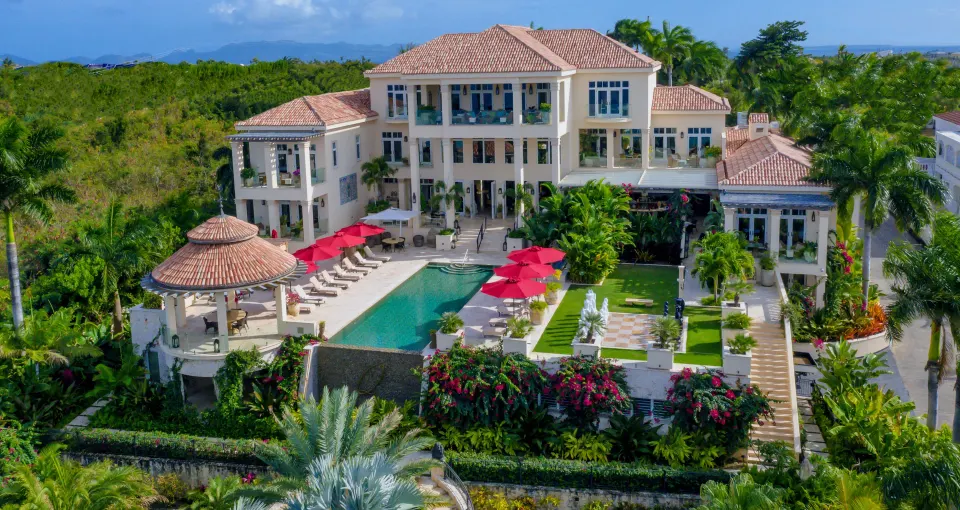 Aerial view of the resort showing pool, gardens and main building at Quintessence Hotel