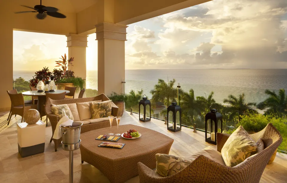 Ocean-view suite terrace with seating and dining at Quintessence Hotel