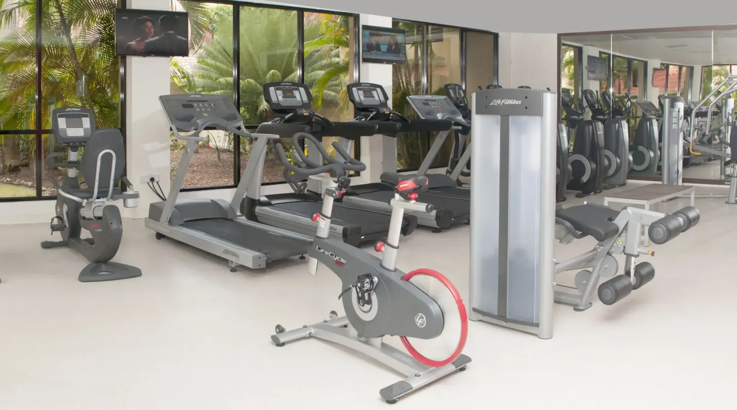Fitness center with bikes, treadmills and weight machines at Radisson Grenada Beach Resort.