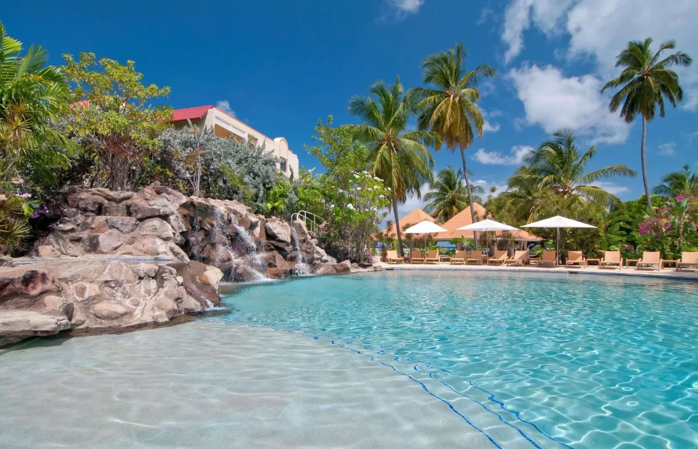 Lagoon-style pool with rock waterfall at Radisson Grenada Beach Resort.