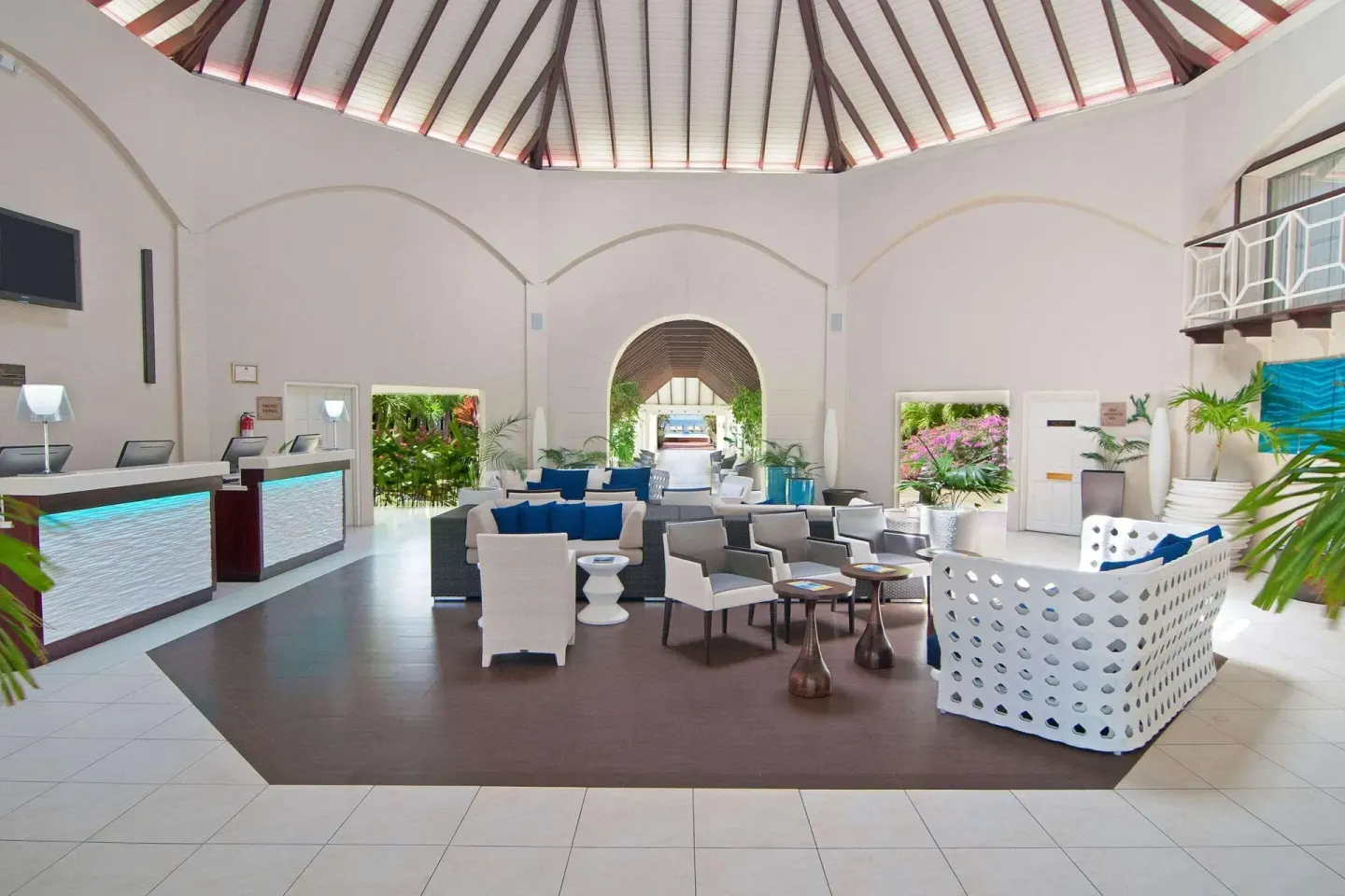 Open-air lobby seating and reception desks at Radisson Grenada Beach Resort.
