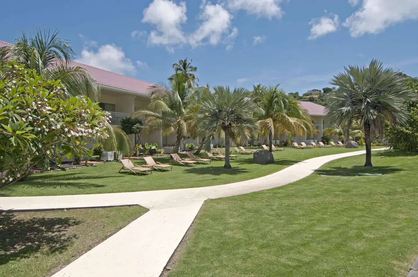 Palm-lined lawn and guest buildings at Radisson Grenada Beach Resort.