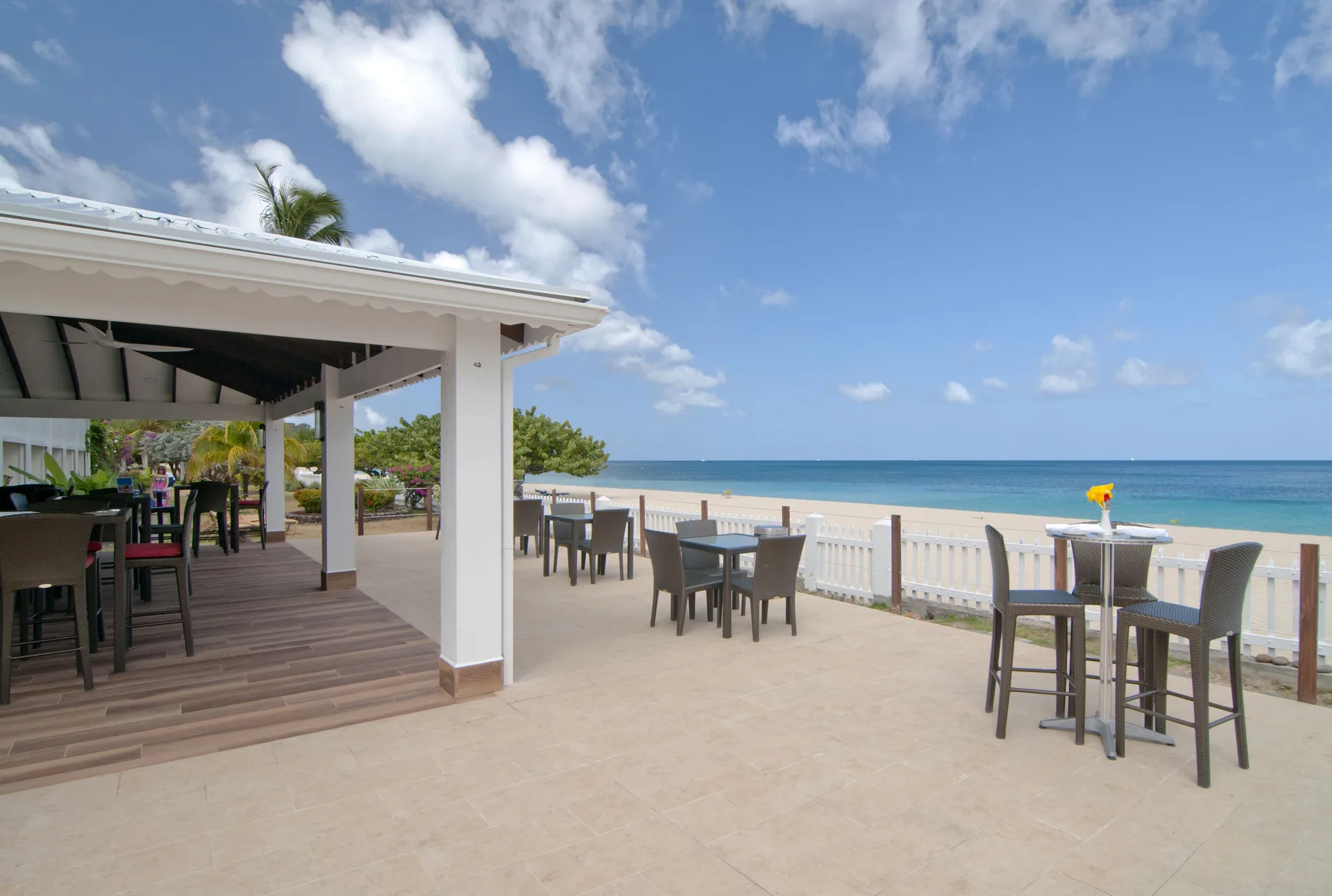Beachfront bar terrace seating at Radisson Grenada Beach Resort.
