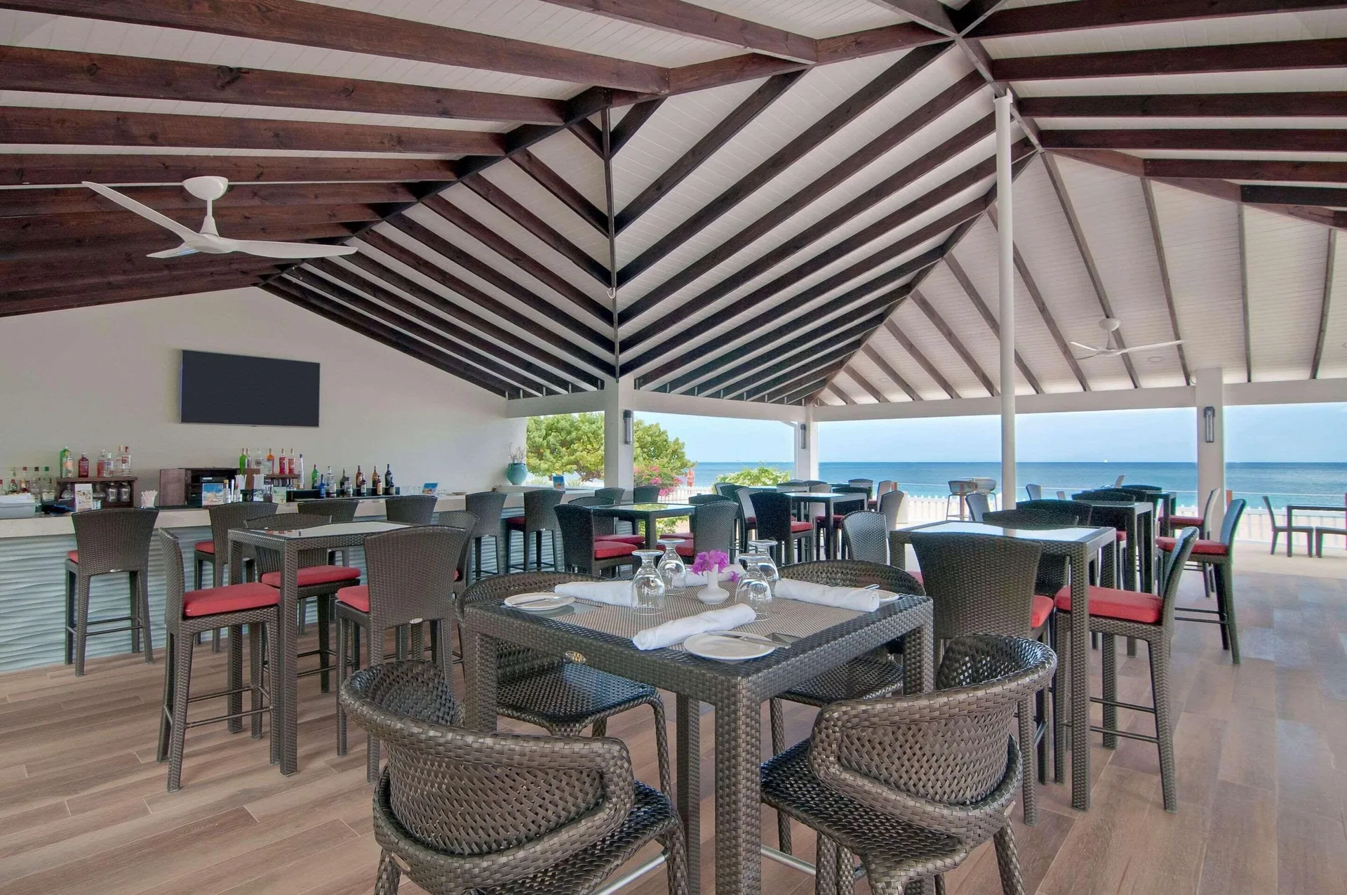 Open-air restaurant and bar with ocean view at Radisson Grenada Beach Resort.