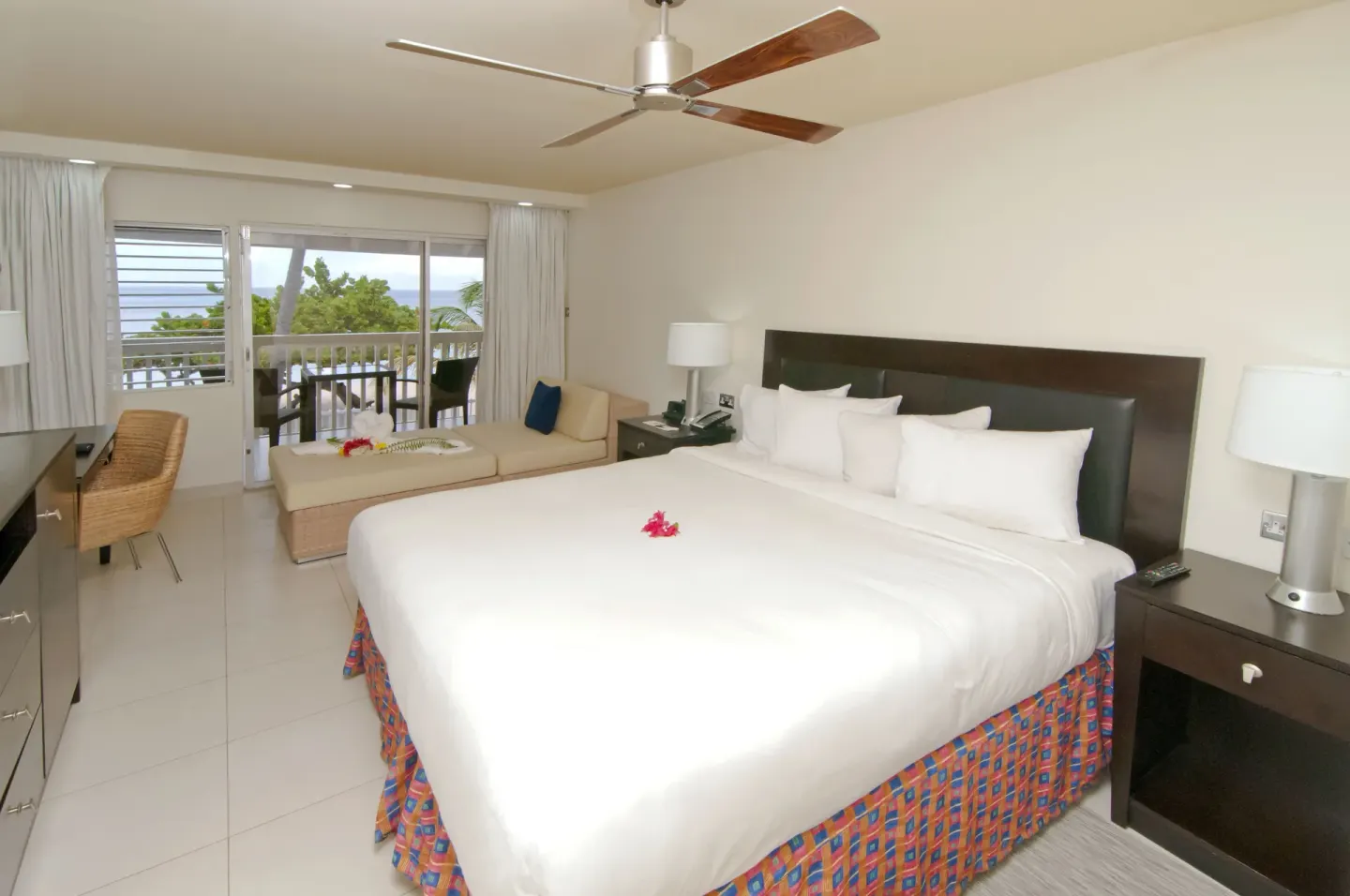 Non Smoking Garden View king room with chaise and balcony at Radisson Grenada Beach Resort.