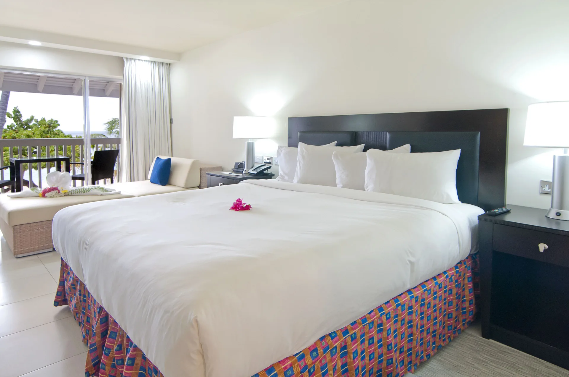 Non Smoking Garden View king bed and bedside tables at Radisson Grenada Beach Resort.