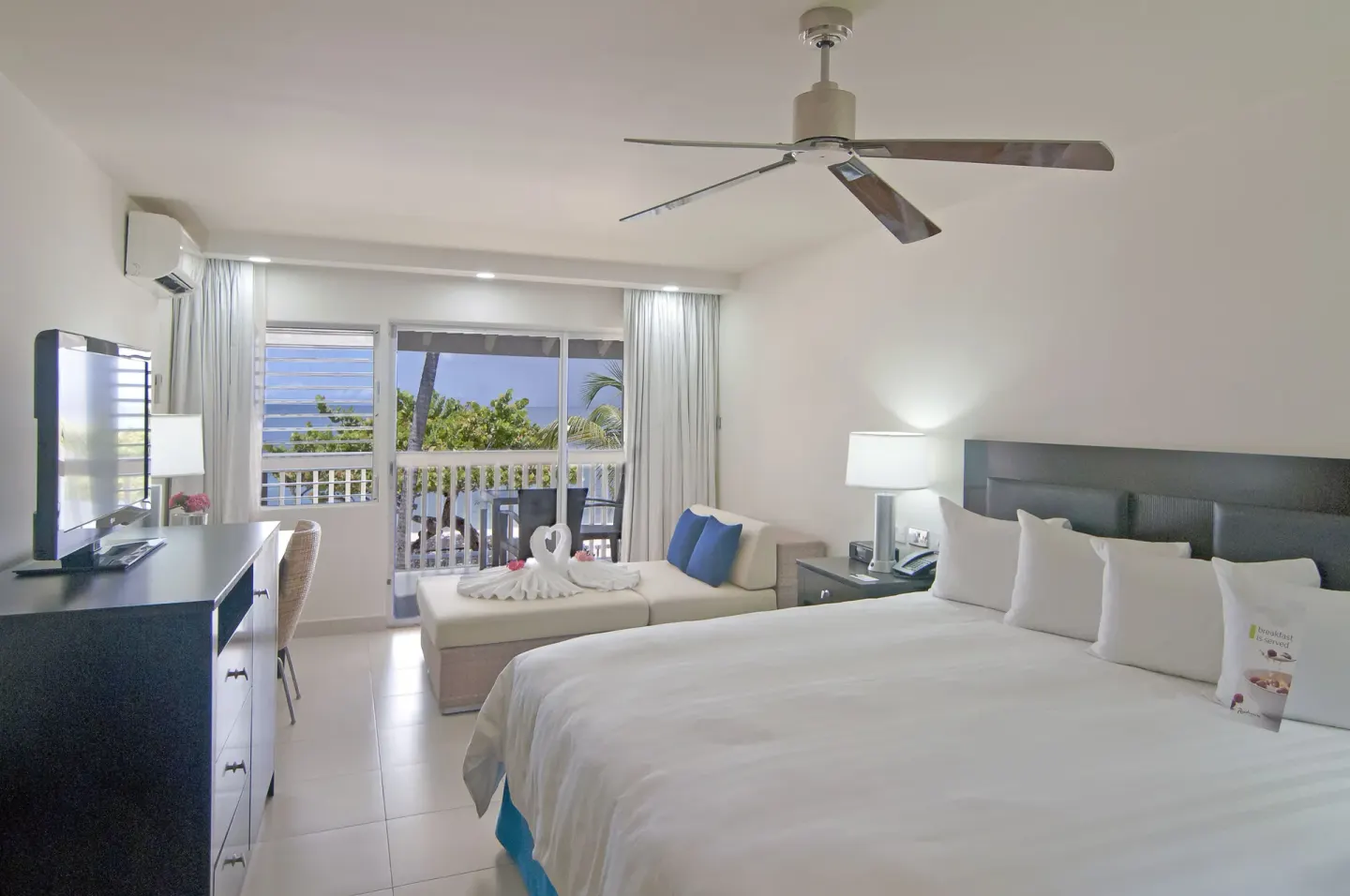 Non Smoking Garden View king room with TV and balcony at Radisson Grenada Beach Resort.
