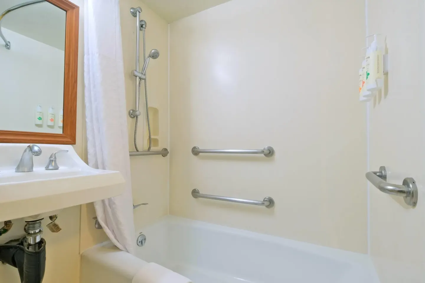 Accessible bathroom tub with grab bars at Ramada Plaza Waikiki.