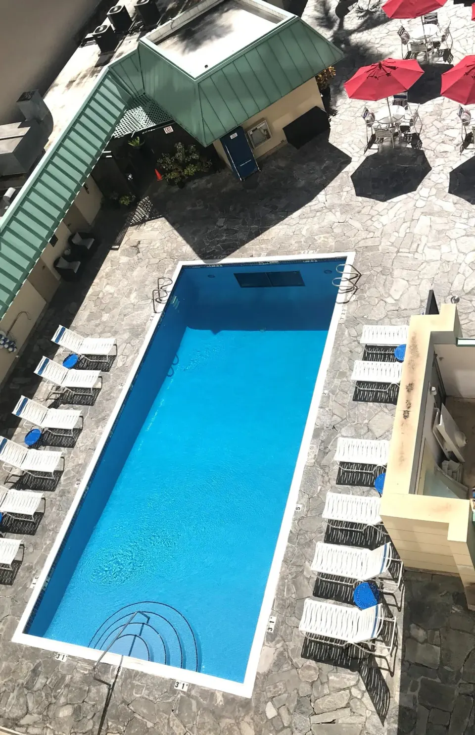 Pool courtyard viewed from a balcony at Ramada Plaza Waikiki.