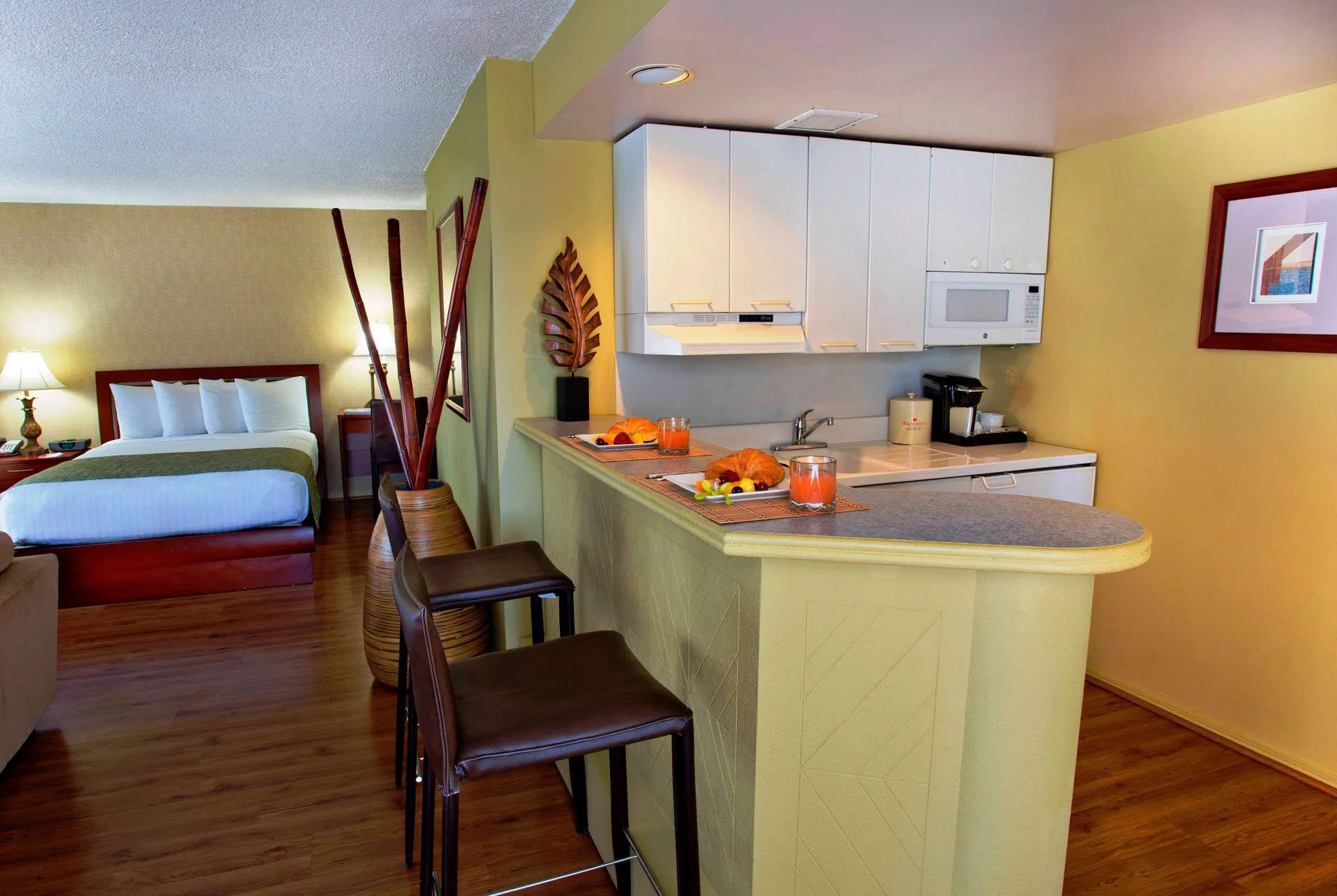 Studio suite kitchenette and bed at Ramada Plaza Waikiki.