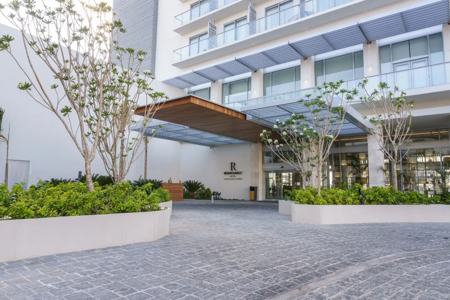 Covered hotel entrance with landscaping at Renaissance Cancun Resort & Marina.