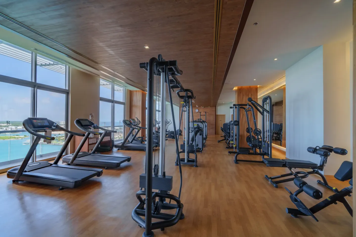 Fitness center with treadmills and weight machines at Renaissance Cancun Resort & Marina.