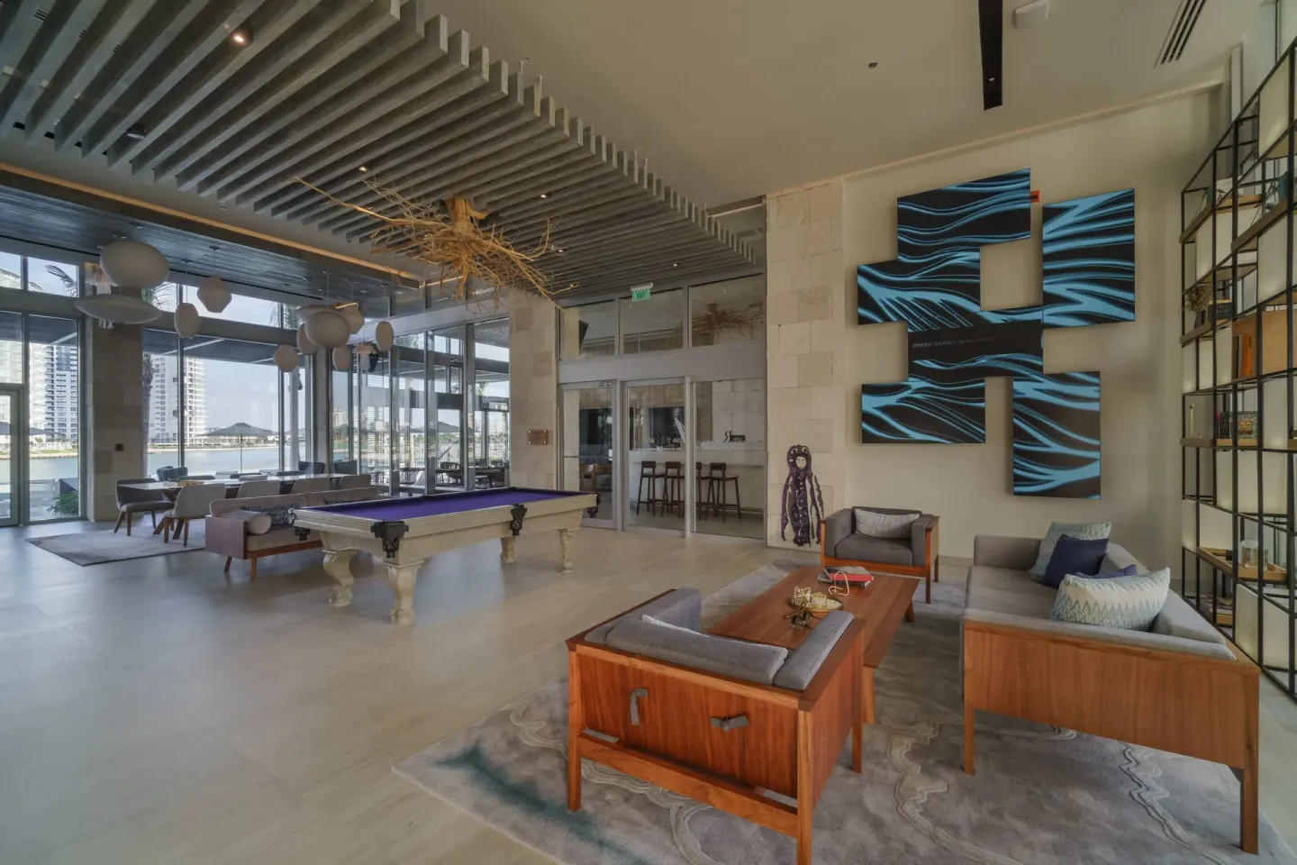 Lobby lounge seating and billiards table at Renaissance Cancun Resort & Marina.