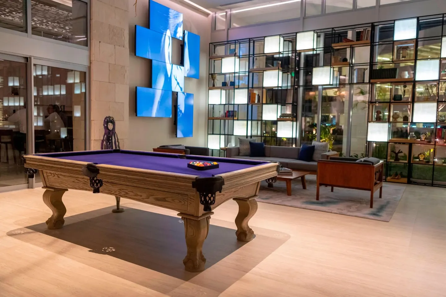 Lobby lounge with a pool table and seating at Renaissance Cancun Resort & Marina.