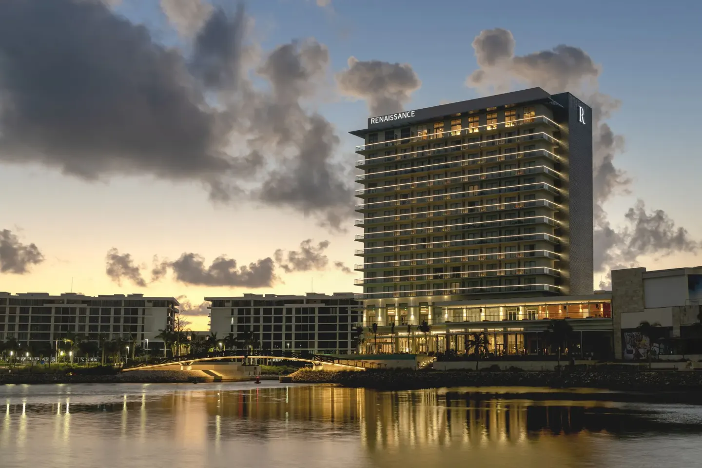 Waterfront hotel exterior at sunset at Renaissance Cancun Resort & Marina.