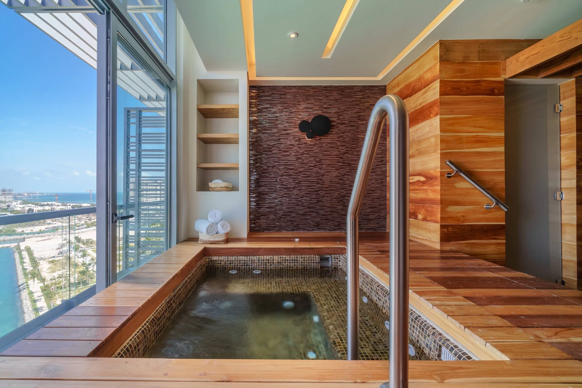 Windowed spa plunge pool with wood decking at Renaissance Cancun Resort & Marina.