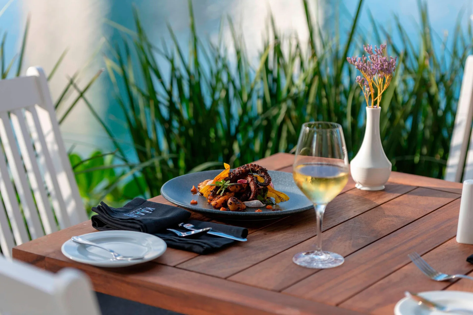 Outdoor seafood dish and white wine at Renaissance Cancun Resort & Marina.