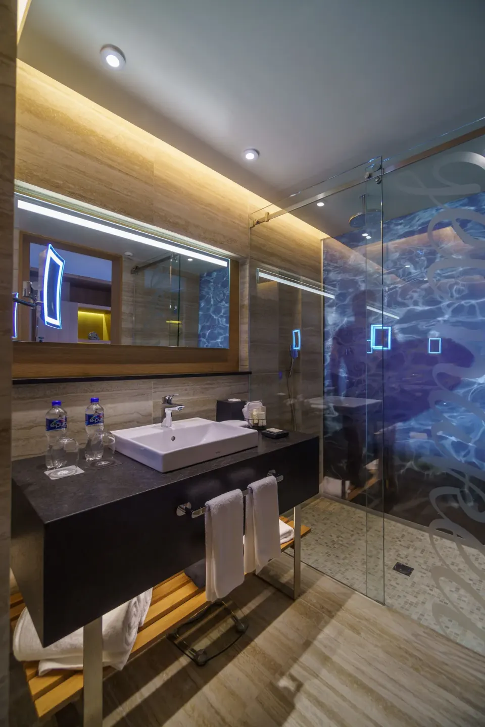 Deluxe Balcony room bathroom with vanity and glass shower at Renaissance Cancun Resort & Marina.
