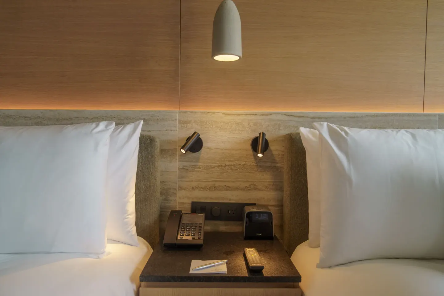 Close-up of two beds and bedside lighting in a Deluxe Balcony room at Renaissance Cancun Resort & Marina.