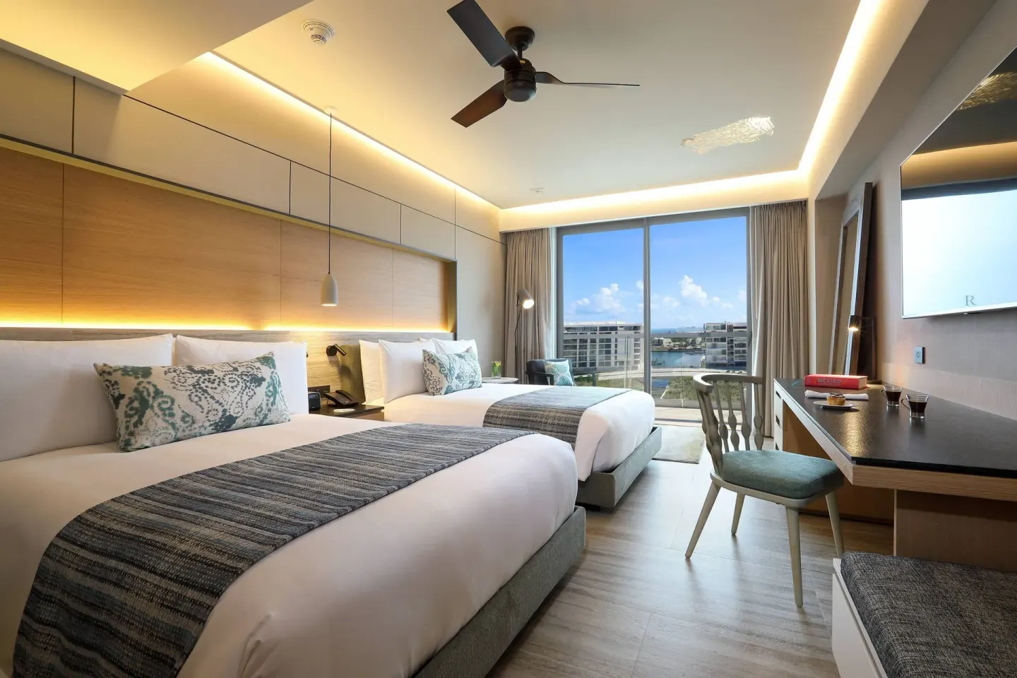 Deluxe Balcony room with two beds and marina-facing windows at Renaissance Cancun Resort & Marina.