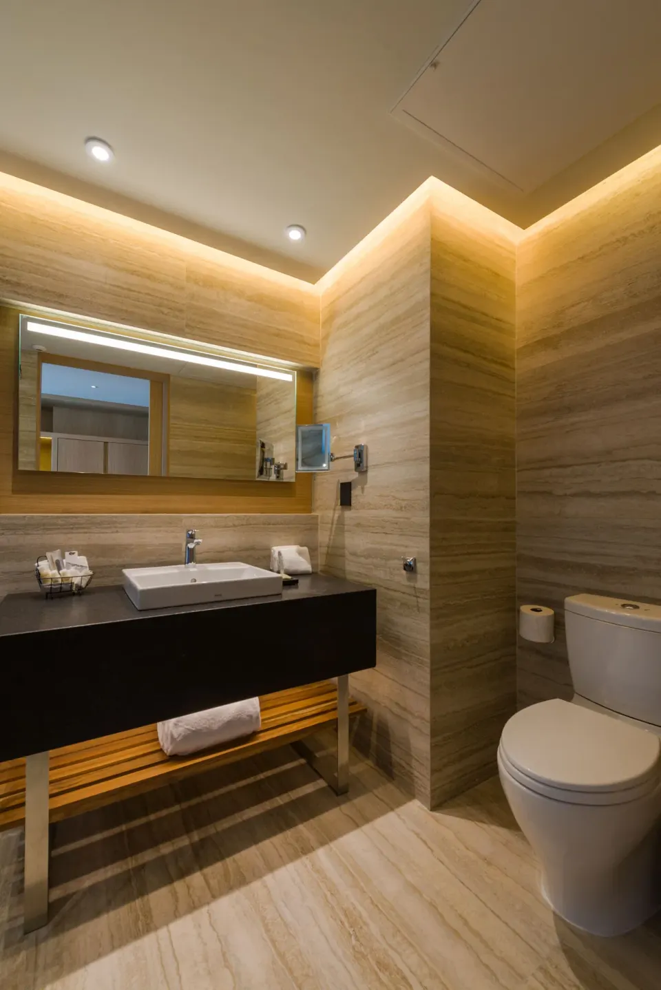 Bathroom vanity and toilet in a deluxe room at Renaissance Cancun Resort & Marina.
