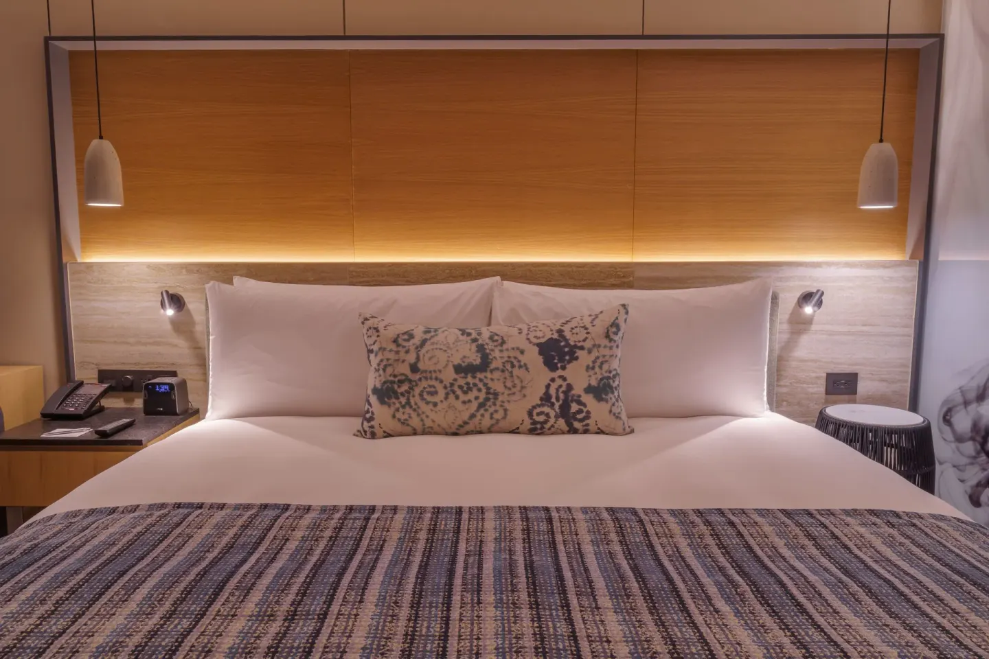 Close view of a king bed and pendant lights at Renaissance Cancun Resort & Marina.