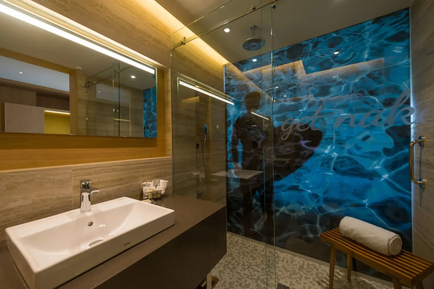 Deluxe Room bathroom sink and glass shower at Renaissance Cancun Resort & Marina.