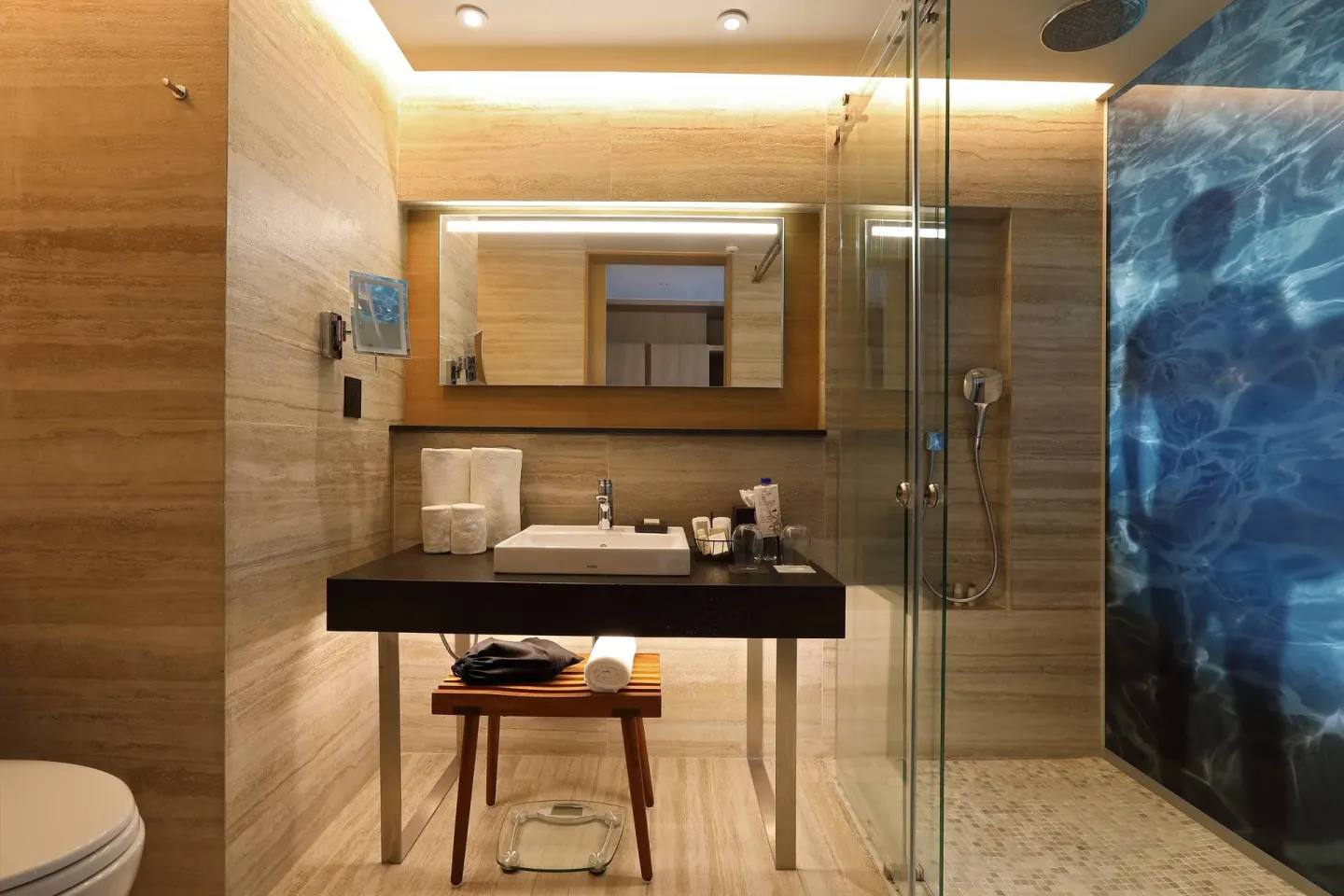 Deluxe Room bathroom vanity and glass shower at Renaissance Cancun Resort & Marina.