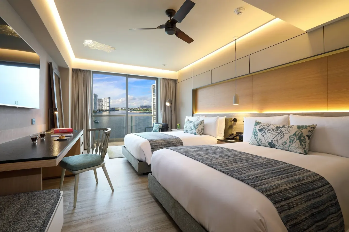 Two-bed Marina View room with desk and balcony at Renaissance Cancun Resort & Marina.