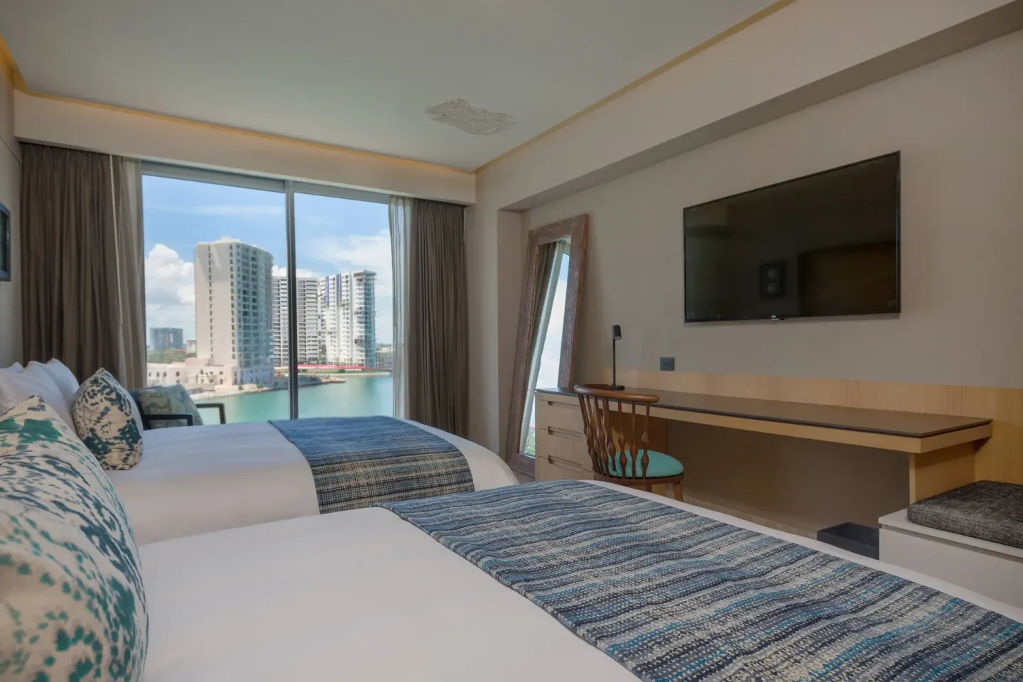 Marina View room with two beds and TV at Renaissance Cancun Resort & Marina.