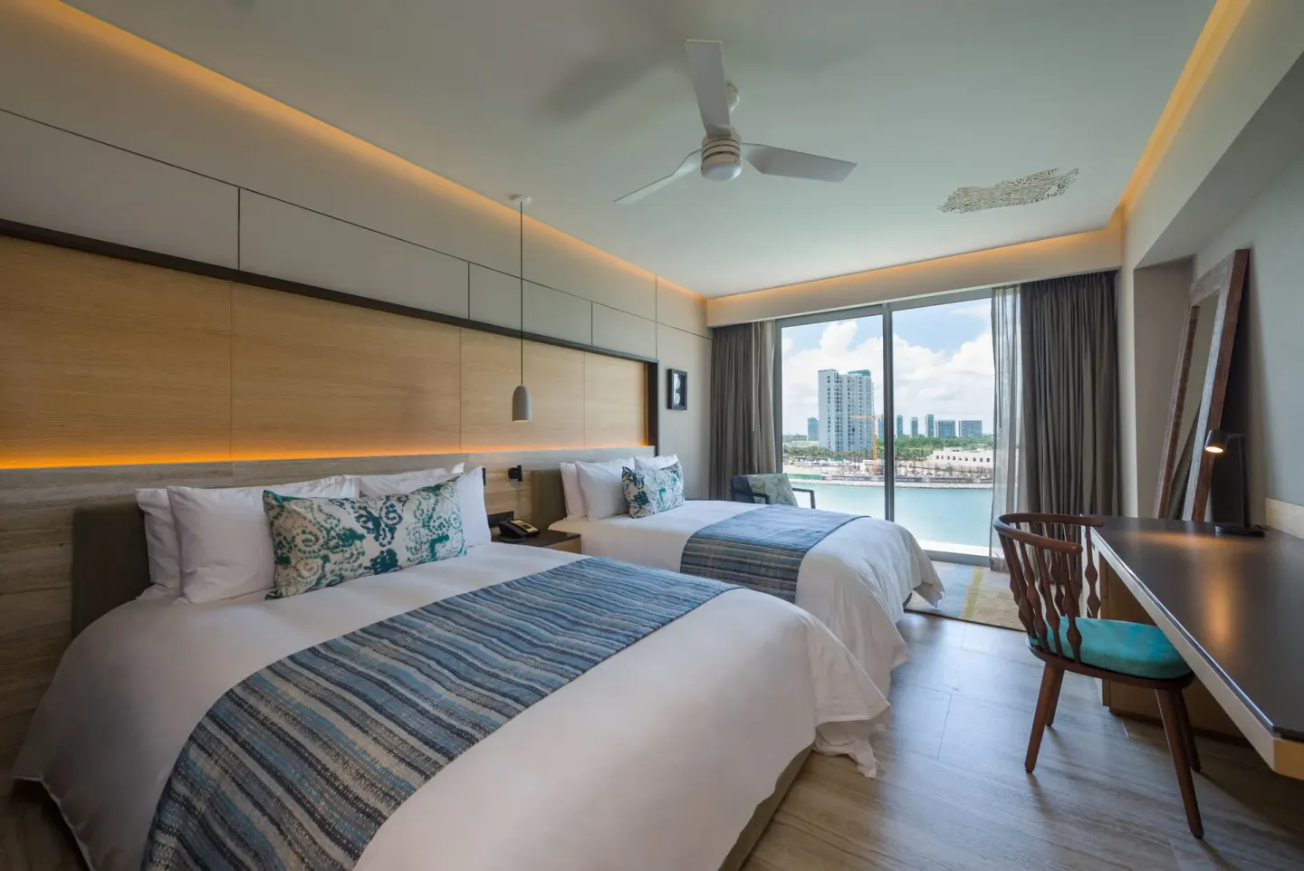 Two-bed Marina View room with balcony window at Renaissance Cancun Resort & Marina.
