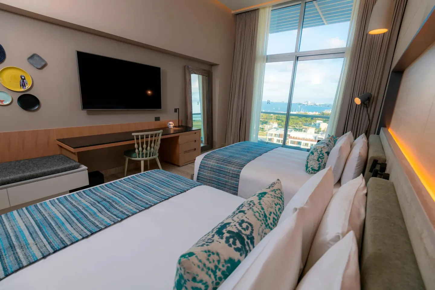 Ocean View balcony room with two beds and large windows at Renaissance Cancun Resort & Marina.