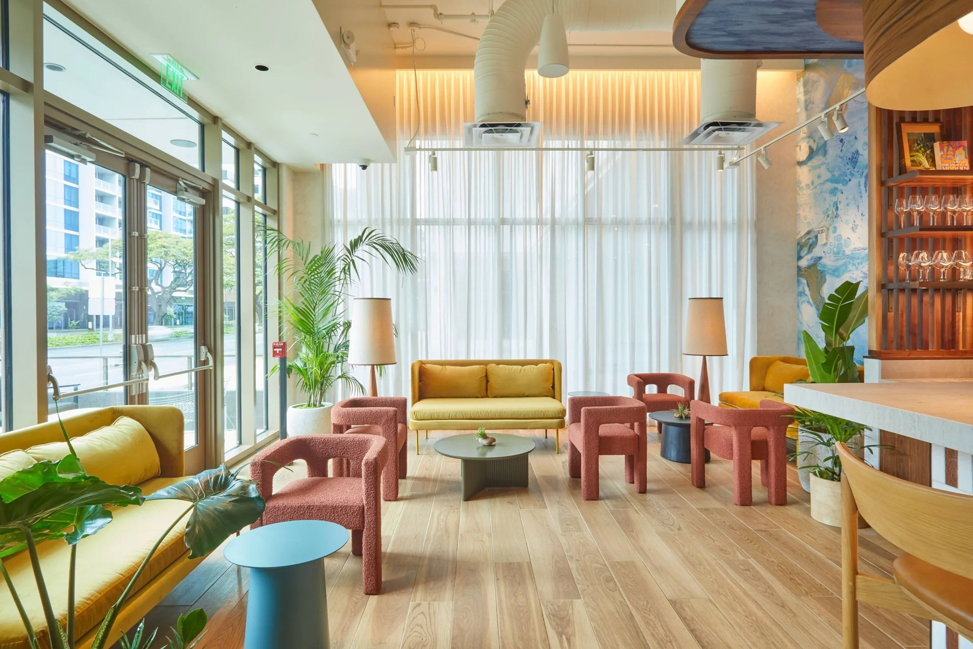 Colorful lounge seating beside large windows at Renaissance Honolulu Hotel & Spa.