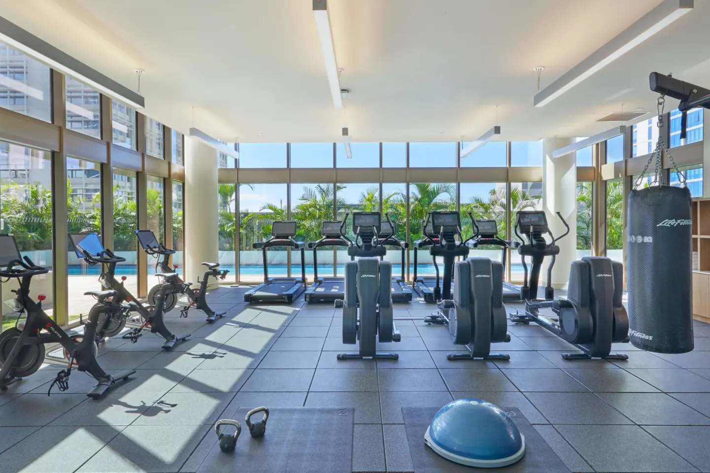 Fitness center cardio equipment facing the pool at Renaissance Honolulu Hotel & Spa.