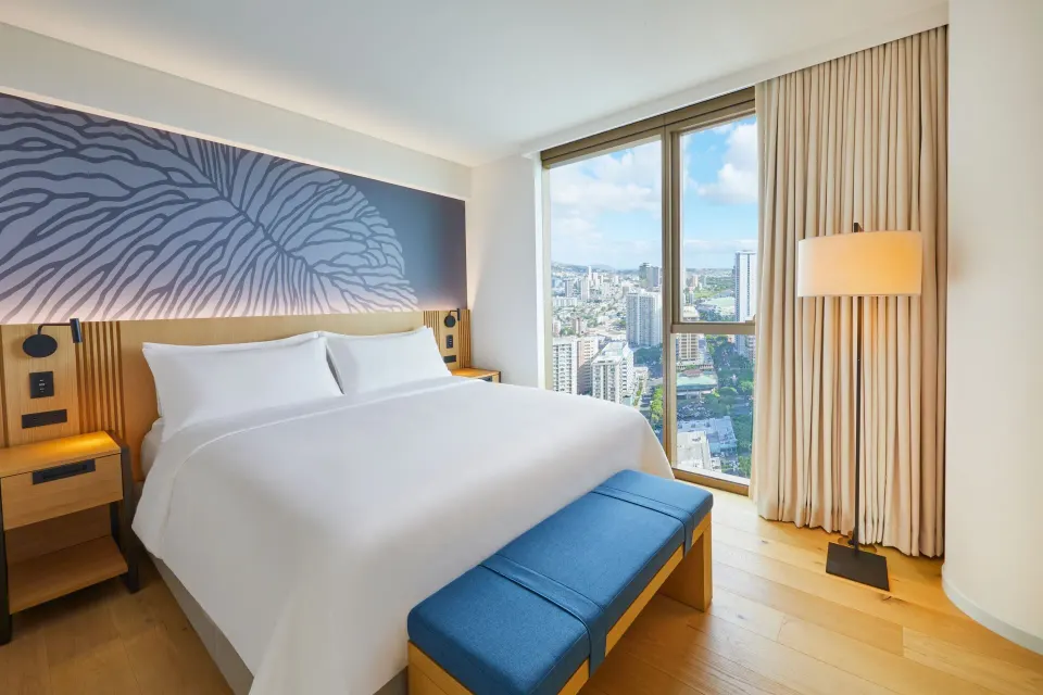 King bed guest room with city view window at Renaissance Honolulu Hotel & Spa.