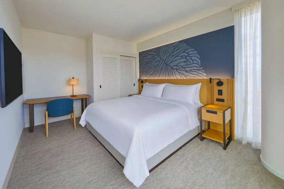 King guest room with white bed and desk at Renaissance Honolulu Hotel & Spa.