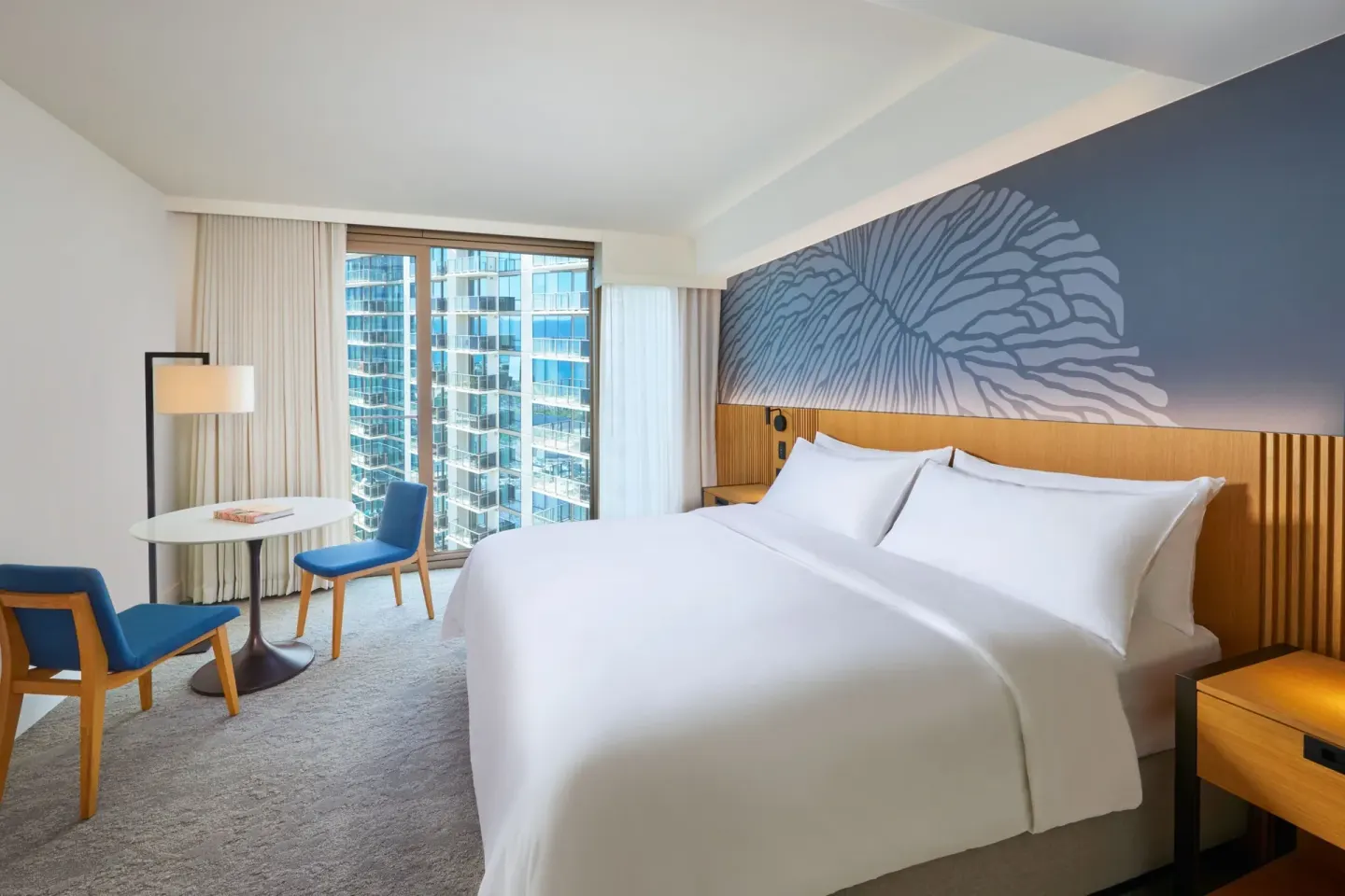 King guest room with seating area and city-facing window at Renaissance Honolulu Hotel & Spa.