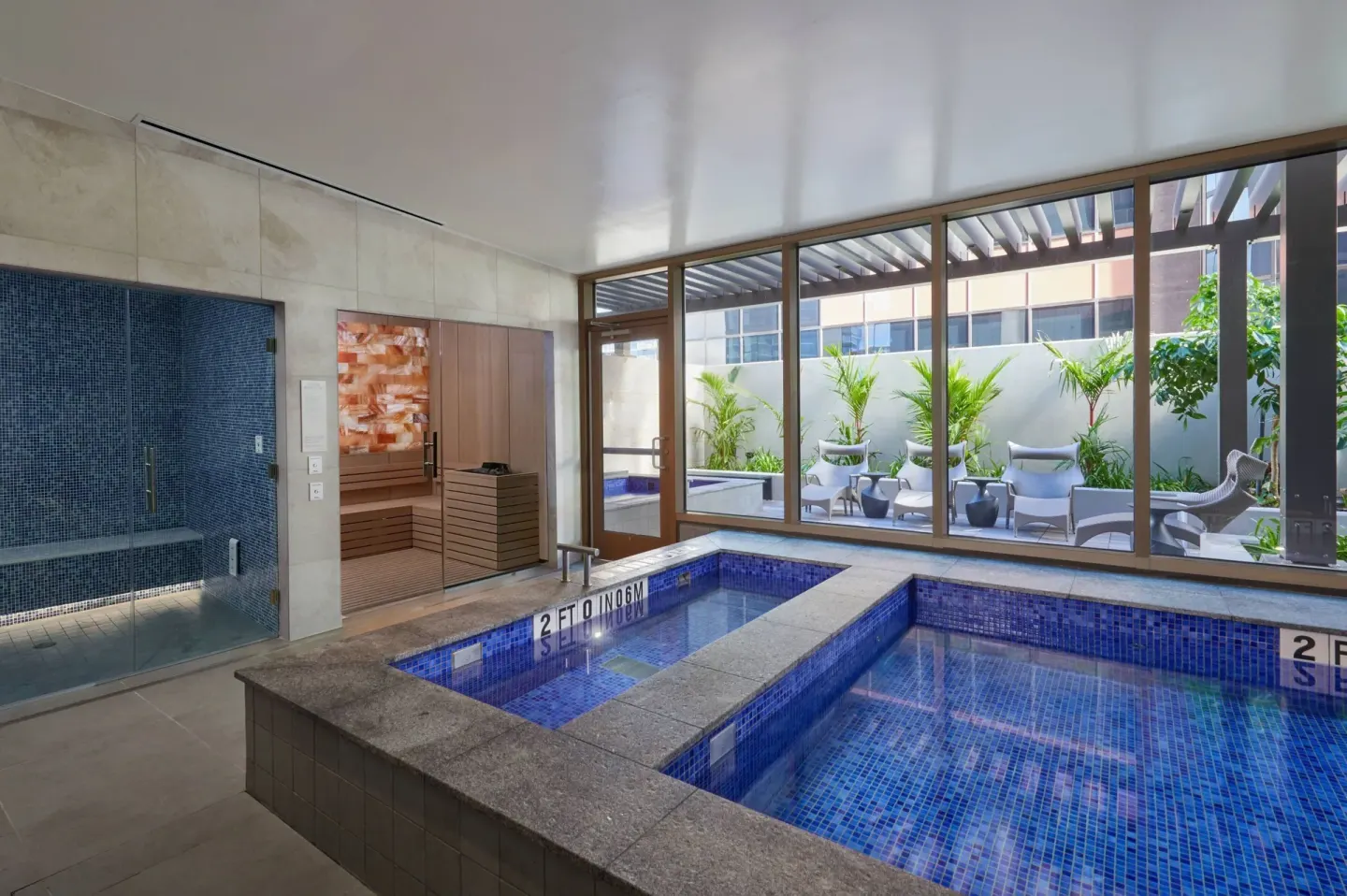 Indoor spa pools, sauna, and seating at Renaissance Honolulu Hotel & Spa.