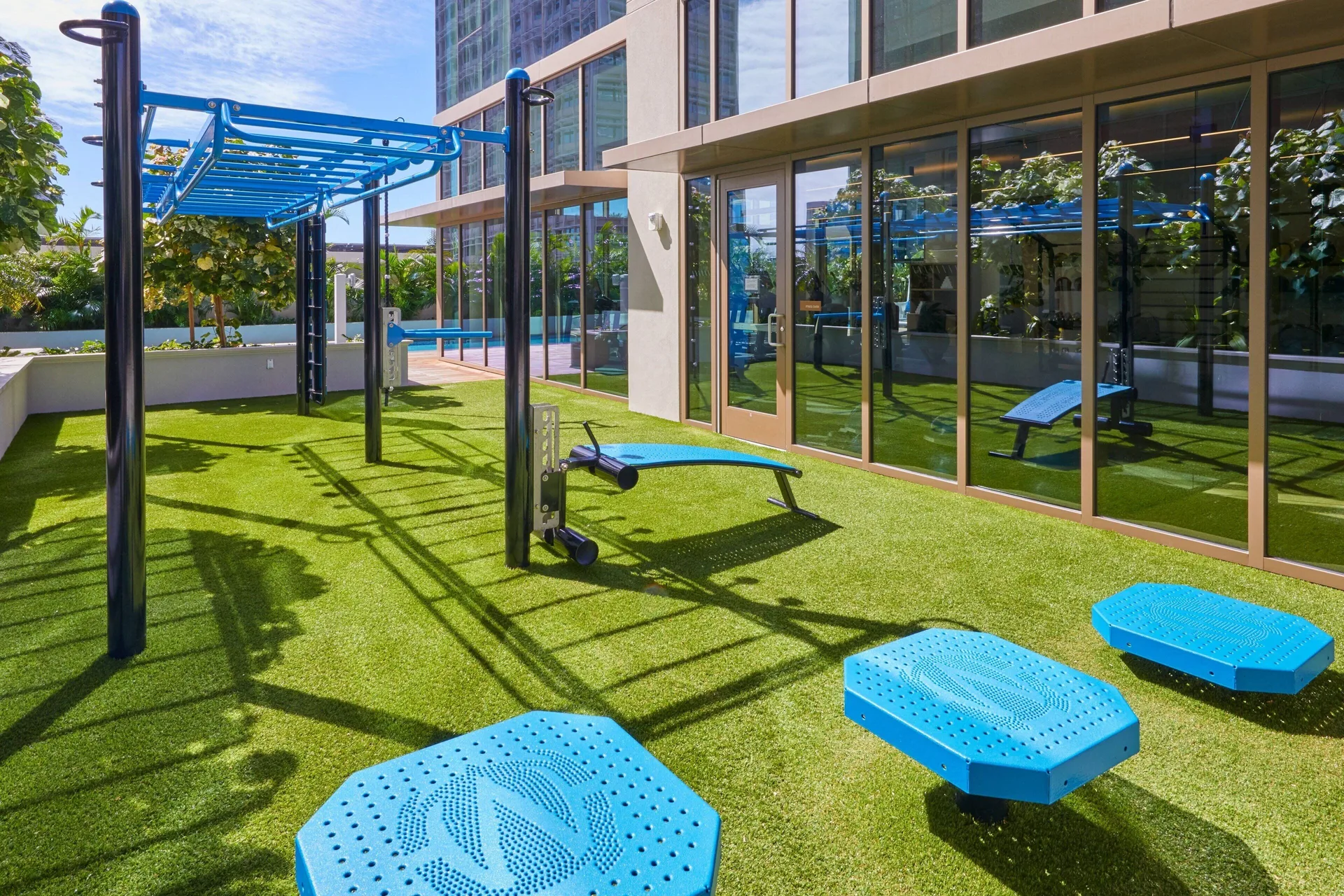 Outdoor fitness turf with blue exercise equipment at Renaissance Honolulu Hotel & Spa.