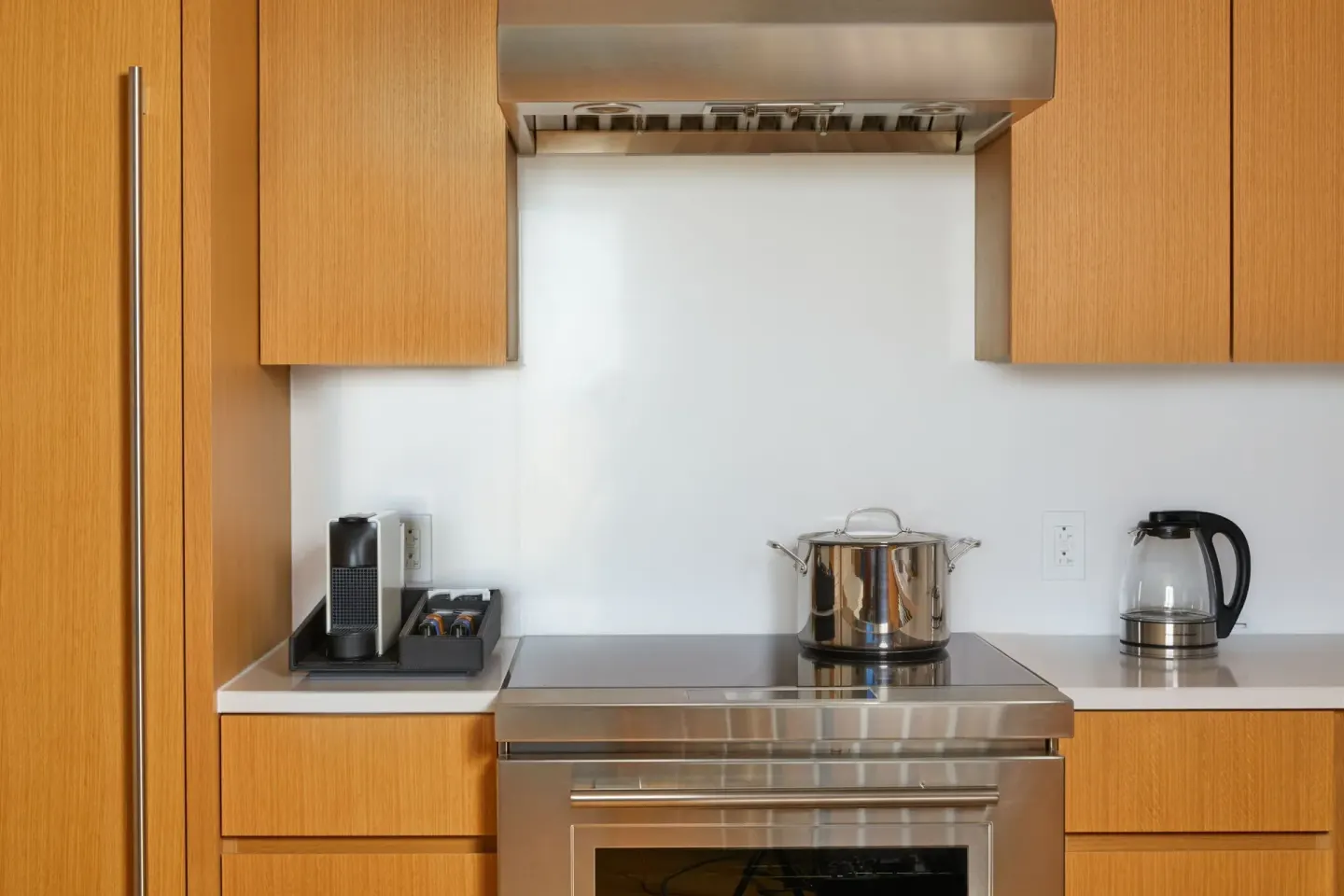Close-up of suite cooktop, range hood, kettle, and coffee setup at Renaissance Honolulu Hotel & Spa.