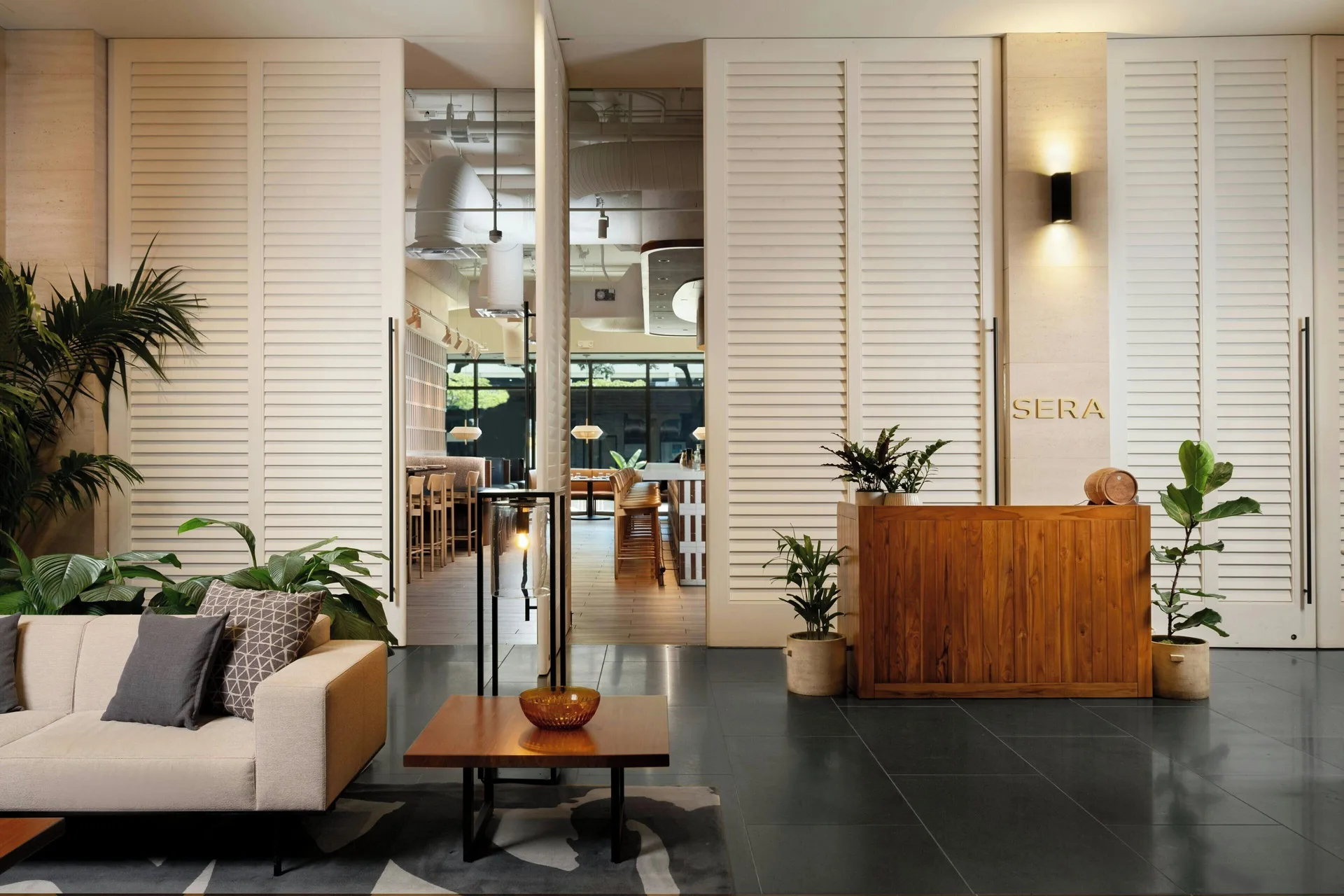 The SERA entrance with a host stand and lounge seating at Renaissance Honolulu Hotel & Spa.