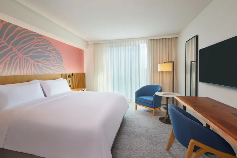 City View Room with king bed, desk, TV, and blue seating at Renaissance Honolulu Hotel & Spa.