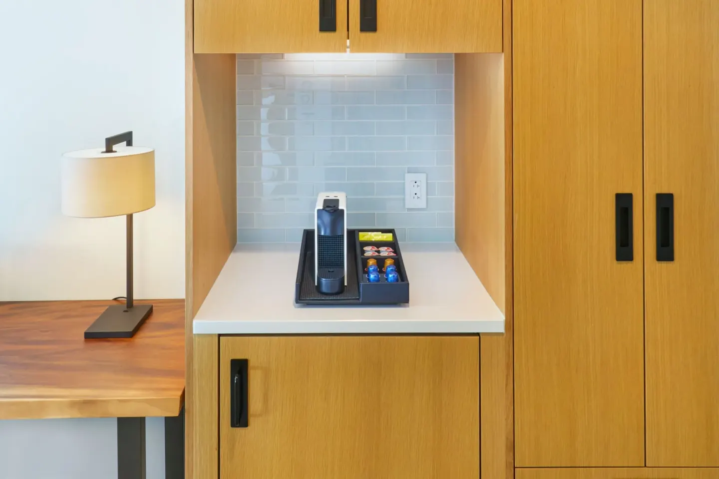 City View Room refreshment nook with coffee maker and wood cabinetry at Renaissance Honolulu Hotel & Spa.