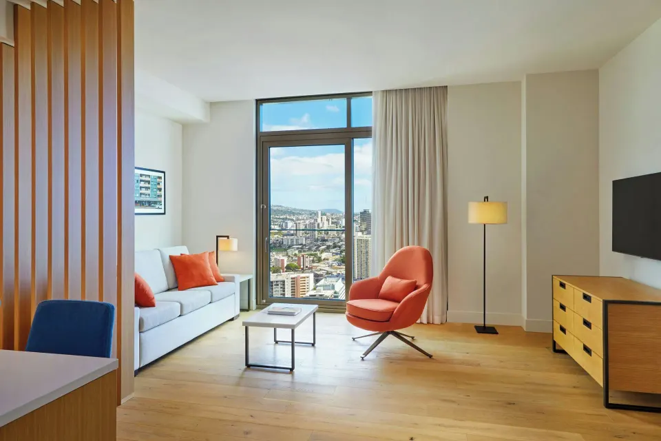 Living area and kitchen edge in the Kaiului Penthouse suite at Renaissance Honolulu Hotel & Spa.